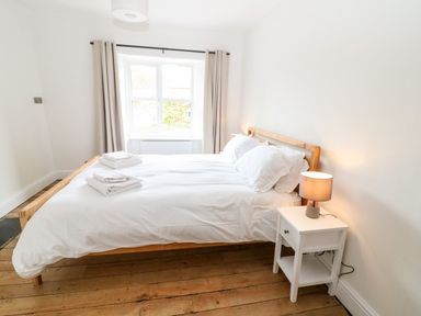 A bedroom with a bed and nightstand at The Old Bakery in Banbury