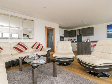 A living room with a sofa and coffee table at Praa Waves in Penzance