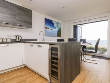 A kitchen with a sink and wine cooler at Praa Waves in Penzance