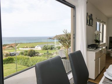 A living room with a view of the ocean at Praa Waves in Penzance