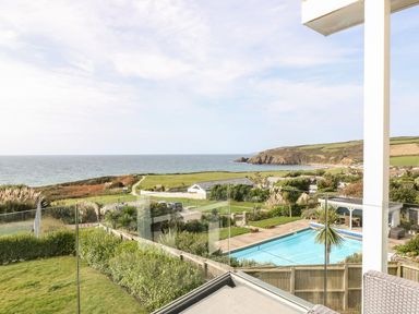 A view of the ocean and swimming pool at Praa Waves in Penzance