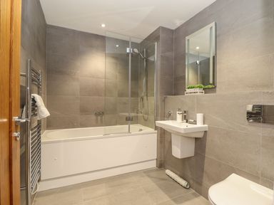 A bathroom with a bathtub and shower at Praa Waves in Penzance