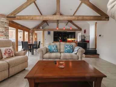 A living room with a sofa and coffee table at Pillar Barn Driffield