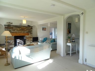 A living room with a fireplace and sofa at Mount Pleasant in Padstow