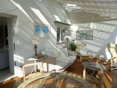 A conservatory with sofas and a table at Mount Pleasant in Padstow