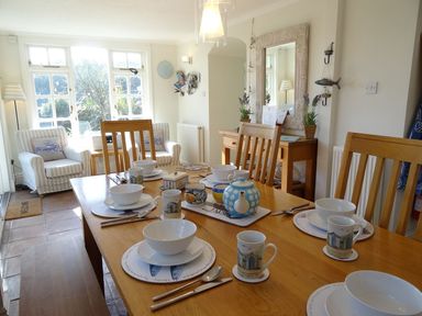 A dining room with a table set for tea at Mount Pleasant in Padstow