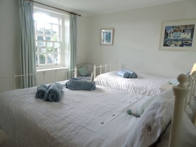 A bedroom with two beds and towels at Mount Pleasant in Padstow