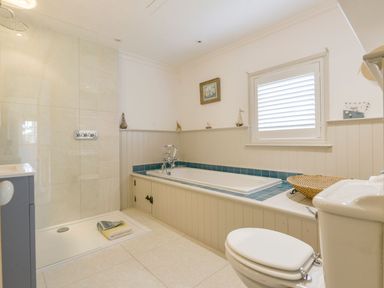 A bathroom with a bathtub and shower at Mount Pleasant in Padstow