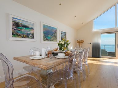 A dining room with a table set for meals at 2 Remera St Ives