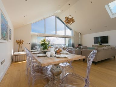 A dining area with a table and chairs at 2 Remera St Ives