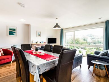A dining room with a table and chairs at Orchard View in St. Austell