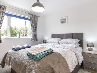 A bedroom with a bed and bedside tables at Orchard View in St. Austell