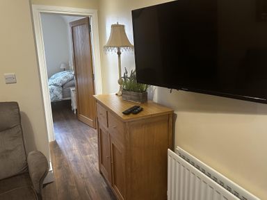 A living room with a television mounted on the wall at The Rocks in Newry