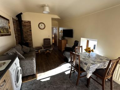 A living room with a sofa and dining table at The Rocks in Newry