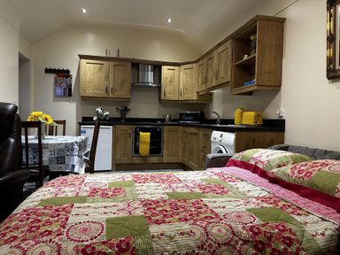 A kitchen with a bed and dining area at The Rocks in Newry