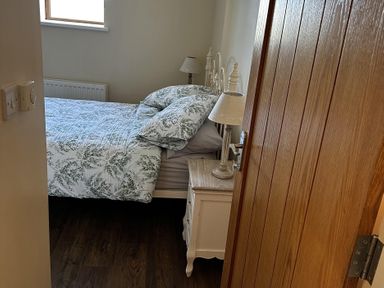 A bedroom with a bed and nightstand at The Rocks in Newry