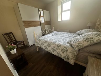 A bedroom with a bed and wardrobe at The Rocks in Newry