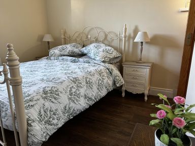 A bedroom with a bed and nightstand at The Rocks in Newry