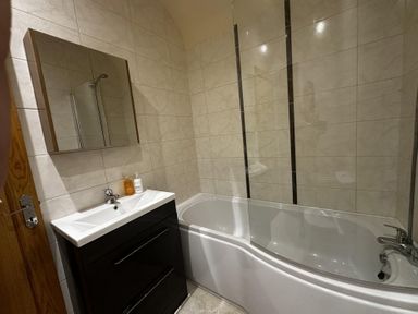 A bathroom with a bath tub and sink at The Rocks in Newry