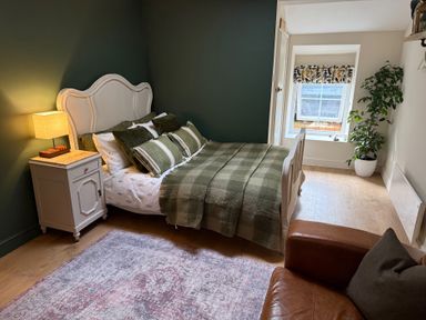 A bedroom with a bed and nightstand at Studio Apartment at High Dyke Farm in Cockermouth