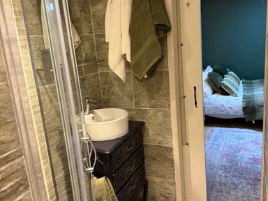 A bathroom with a sink and shower at Studio Apartment at High Dyke Farm Cockermouth