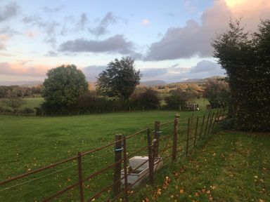 A landscape with a fence and trees at Studio Apartment at High Dyke Farm Cockermouth