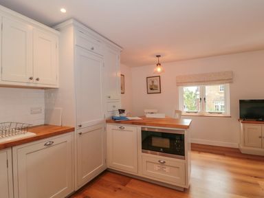 A kitchen with cabinets and a countertop at Greenham Rise in Norton-Sub-Hamdon