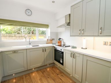 A kitchen with modern cabinets and appliances at Tymelyn in Aberystwyth
