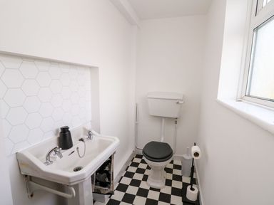 A bathroom with a sink and toilet at Tymelyn in Aberystwyth
