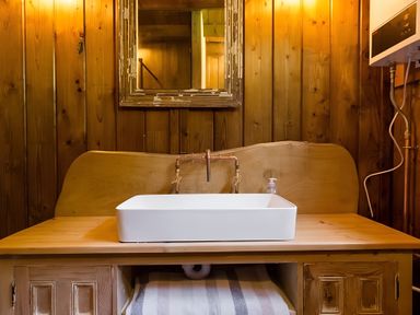 A sink and faucet with a mirror at Badger - Luxury Glamping Retreat, Battle