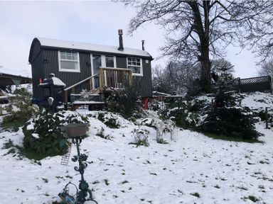 A shelter surrounded by snow in the garden at Tylands in Camelford