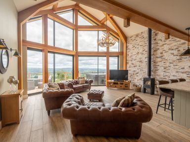 A living room with a couch and television at Valley View Lodge 1 Preston