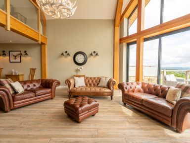 A living room with three sofas and a coffee table at Valley View Lodge 1 Preston