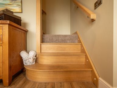 A staircase with wooden steps and railing at Valley View Lodge 1 Preston