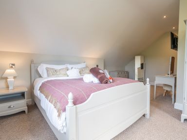 A bedroom with a bed and nightstand at Valley View Lodge 1 Preston
