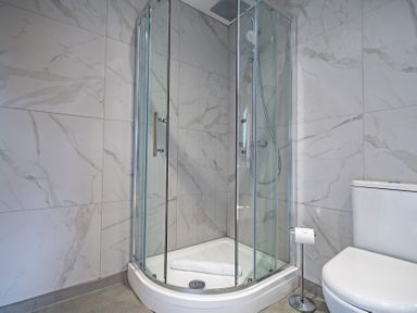 A bathroom with a shower and a toilet at Pendle View in Preston
