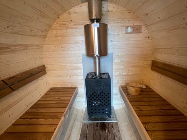 A sauna with wooden benches and a stove at Pendle View in Preston
