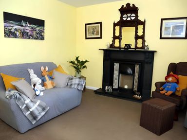 A living room with a sofa and a fireplace at The Farmhouse in Omagh