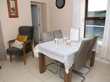 A dining room with a table and chairs at The Farmhouse in Omagh
