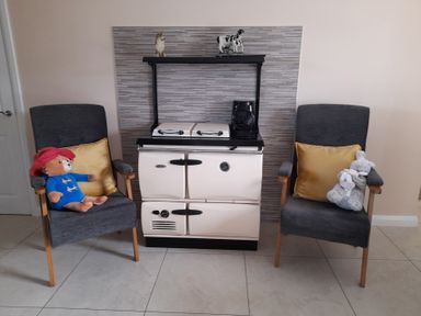 A cooking range with two chairs and stuffed toys at The Farmhouse in Omagh