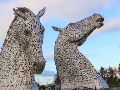 Two large horse sculptures in a public area at Beechtree Timber Lodge 69A in Denny