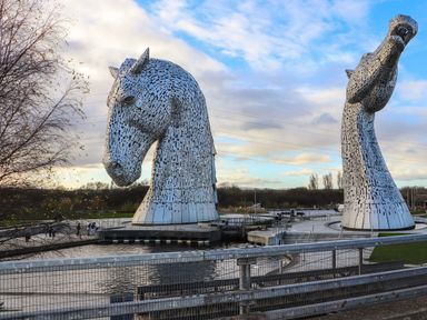 Two horse sculptures near water at Beechtree Timber Lodge 69A in Denny