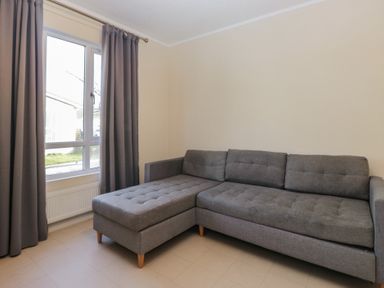 A living room with a sectional sofa and curtains at Beechtree Timber Lodge 69A in Denny
