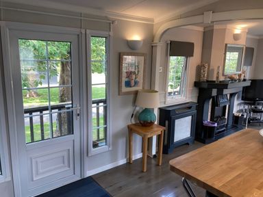 A dining room with a door and windows at Caravan 38 in Newport