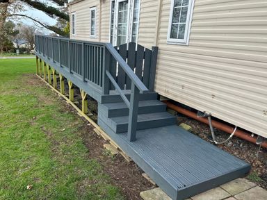 A wooden deck with steps in an outdoor area at Caravan 38 Newport
