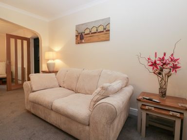 A living room with a sofa and lamp at Mables in Wigton