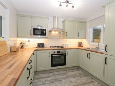 A kitchen with cabinets and appliances at Mables in Wigton
