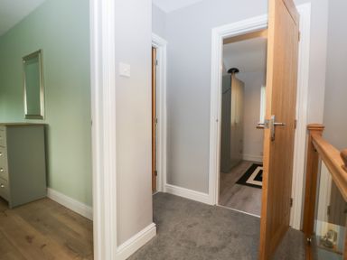 A hallway with a dresser and doors at Mables in Wigton