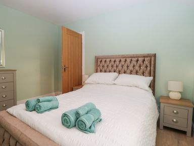 A bedroom with a bed and bedside table at Mables in Wigton