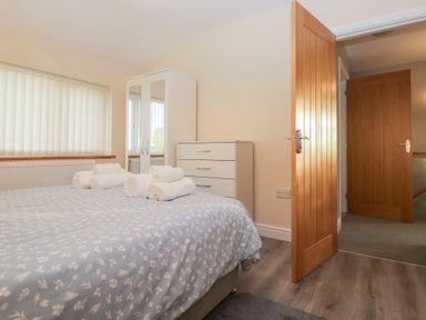 A bedroom with a bed and wardrobe at Mables in Wigton